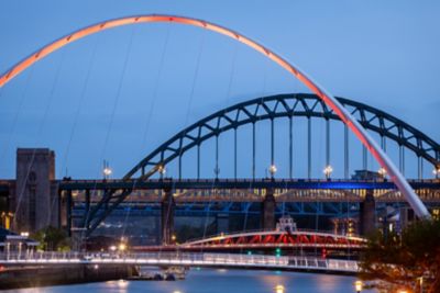 Gateshead Millennium Bridge in Newcastle upon Tyne, illuminated at night