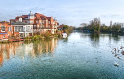 Historic buildings overlooking the peaceful River Thames in Windsor, England
