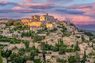 Stone houses and shrubbery perched on a hillside in Gordes village, Provence