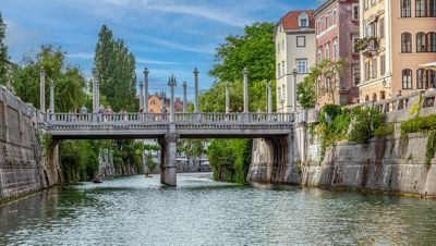 The beautiful Cobbler's Bridge in Ljubljana, with lamplights on elegant pillars