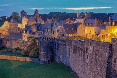 The tall, weathered stone walls of medieval Fougères Castle in France