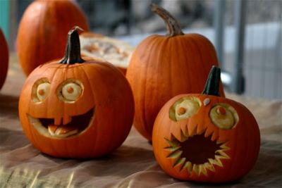 Quirky jack-o'-lanterns with skewed eyes and silly grins