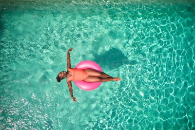 A traveller relaxing in a tranquil swimming pool like those in Novotel hotels