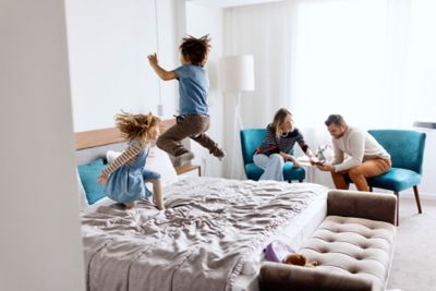 Parents and children enjoying their room in a family hotel
