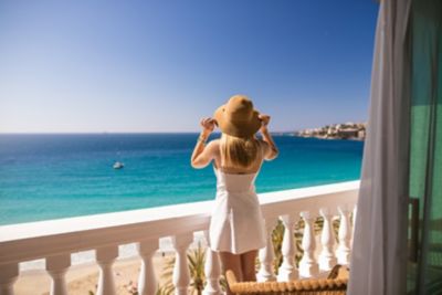 A traveller enjoying the view from a balcony, part of a morning travel routine