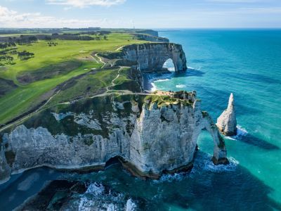 The chalk cliffs and sculptural sea arches of Étretat, Normandy, with scenic trails