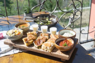 A delicious platter of Albanian food, including byrek pie and fërgesë stew