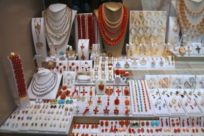 A shop window display of colourful coral jewellery in Dubrovnik, Croatia