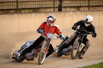 Speedway riders navigating a tight bend