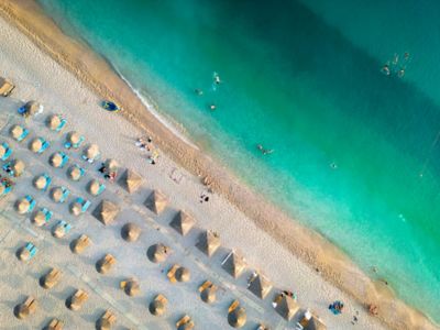 Swimmers and sunbathers enjoying the clear waters of Albania's Adriatic Coast