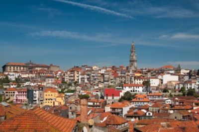 The Baroque Clérigos Tower rising above the orange rooftops in Porto