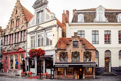 The quaint brick façade of Chocolatier Dumon in Bruges Old Town, Belgium