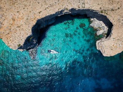 A boat at the tranquil Blue Lagoon in Malta, known for its clear Mediterranean waters