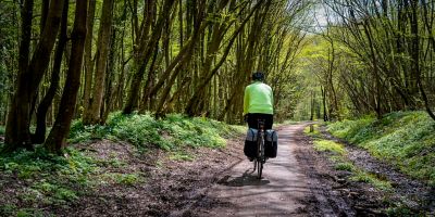 A leisurely cyclist on the flat, well-paved surface of the Cuckoo Trail, South Downs