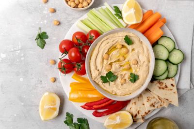 A mezze picnic platter with hummus and cut veggies, an ideal hot weather recipe