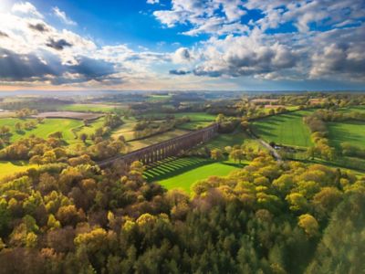 Ouse Valley Viaduct in the South Downs National Park, surrounded by bright green fields and trees