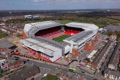 Anfield Stadium in Liverpool surrounded by houses, a car park and countryside