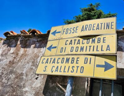 Signs along the Appian Way in Rome pointing to the various catacombs