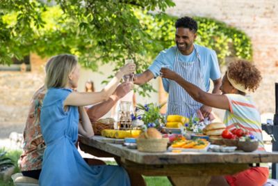 A group of friends enjoying recipes for hot weather in the shade of a garden