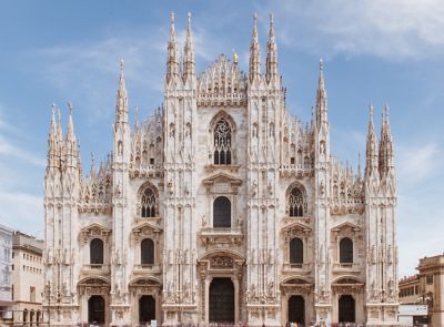 The impressive Gothic façade of Milan Cathedral, in white marble with statue-topped spires