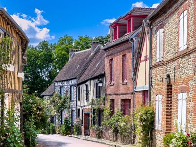 Half-timbered houses with colourful roses on a lane in Gerberoy village, Picardy