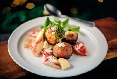 A plate of aebleskiver daintly presented in a fine dining restaurant