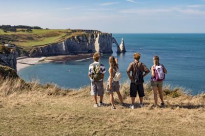 A family gazing at the Alabaster Coast cliffs in Normandy, France