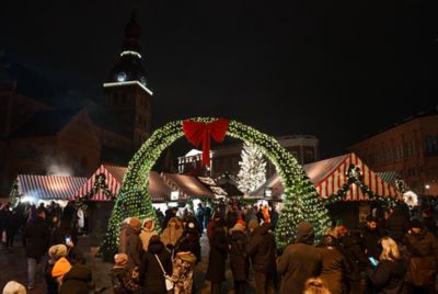 A large arch and an illuminated tree at a Christmas market in Riga, Latvia