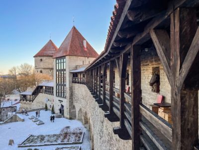 The weathered stone and wooden beams of the medieval fortress wall in Tallinn Old Town