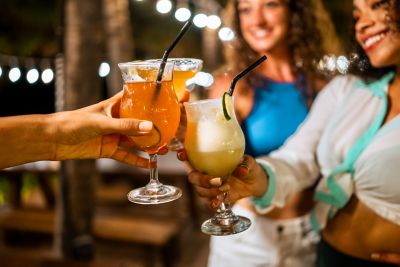Friends enjoy a casual night out with tropical cocktails