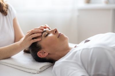 A wellness seeker enjoying a head massage in a serene spa