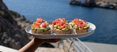 Sourdough bread topped with avo and tomato, part of a mindful eating habit
