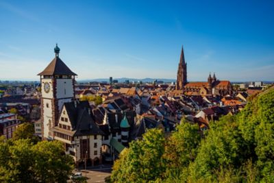 Toits des habitations et clocher de la cathédrale de Fribourg-en-Brisgau, sous un ciel dégagé lors d’une journée ensoleillée