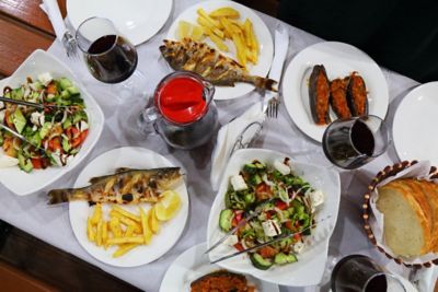 Traditional food in Albania, including fried fish, stuffed aubergine and salads