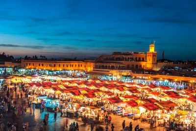 Rows of illuminated food stalls in bustling Djemaa el-Fna Square in Marrakech