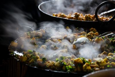 Steaming pans of cooked food at a Borough Market stall in London