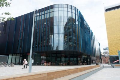 The curving glass façade of HOME art gallery in Manchester