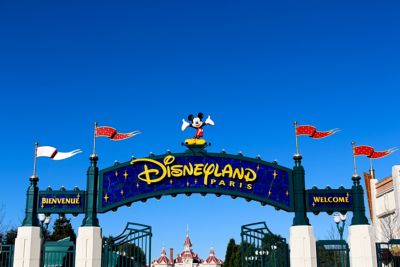 The entrance gates of Disneyland Paris, with a grinning Mickey and jaunty pennants