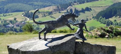 An outdoor sculpture of a warrior vanquishing the Beast of Gévaudan, France