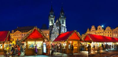 Wooden stalls in front of Týn Church at the Christmas market in Prague's Old Town Square