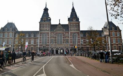 Passants devant le Rijksmuseum, musée emblématique vu depuis le pont Museumbrug