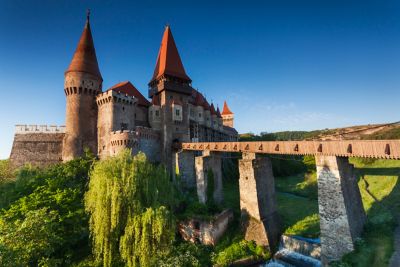 Impressive Corvin Castle and its medieval bridge at sunset