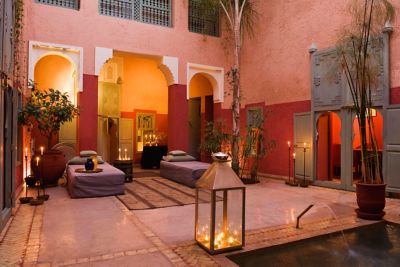 A tranquil courtyard at a riad in Marrakech, illuminated by glowing candles