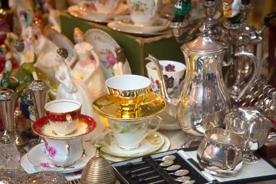 Vintage tea sets and silverware at an antiques market in England