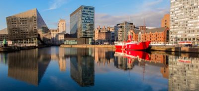 Liverpool's Salthouse Dock, with contemporary glass buildings reflected in the calm water