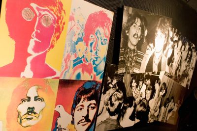 Black-and-white photos and a pop art canvas of The Beatles in The Beatles Museum in Liverpool