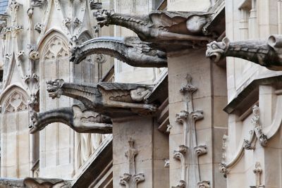 Winged, serpentine gargoyle statues in Rouen Old Town, France