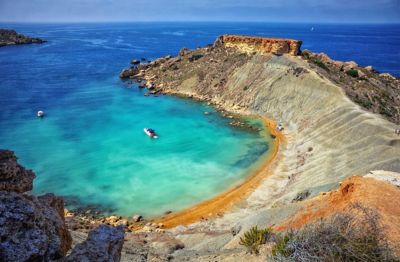 Gnejna Bay, Malta, with a golden-sand beach and the blue Mediterranean Sea