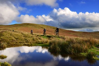 Mountain bikers on an uphill trail in the vast Bannau Brycheiniog National Park