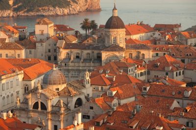 The orange rooftops and domes of Dubrovnik's Old Town in sunset's golden light